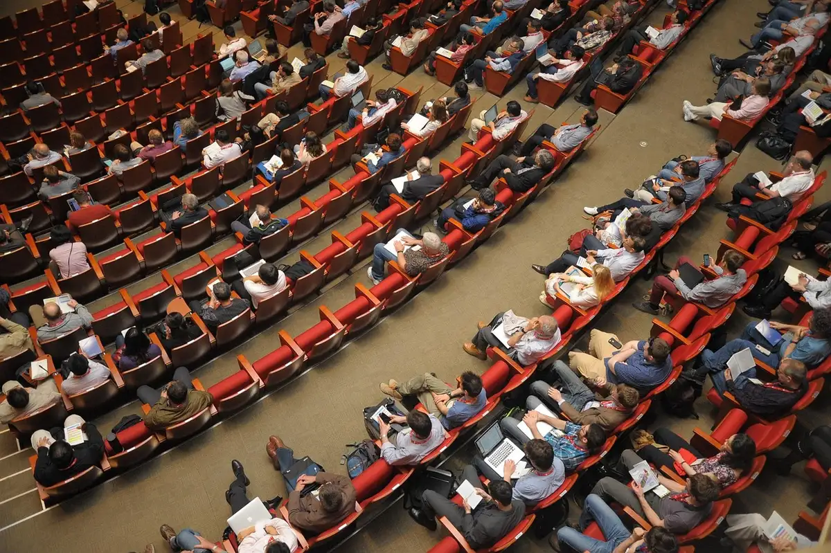Crowd networking in a bright exhibition hall at a TV market