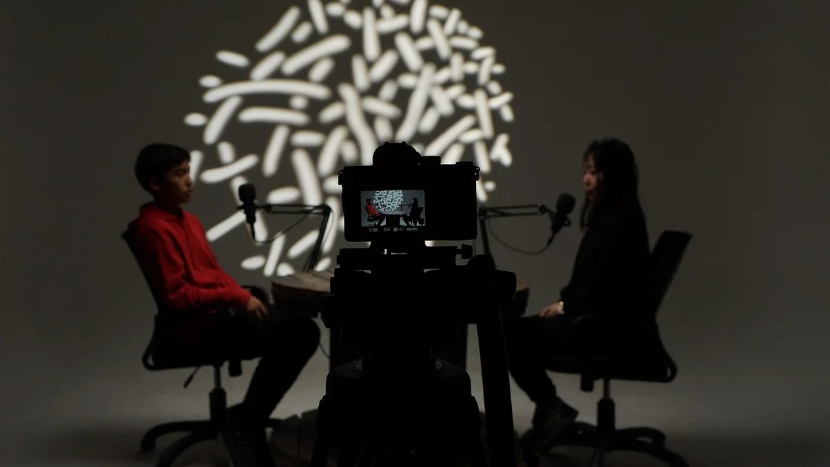 Documentary filmmaker directing crew on location during an interview shoot