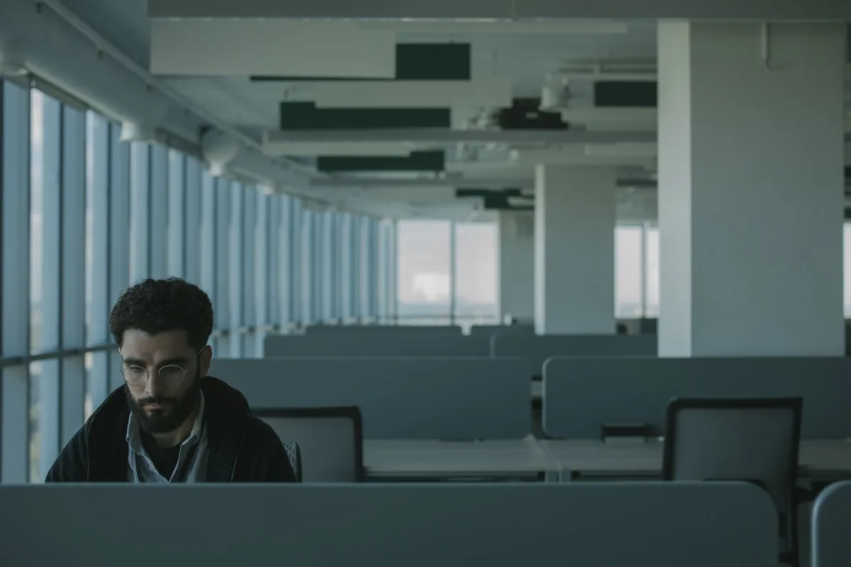 Empty office desks after layoffs illustrating Netflix restructuring